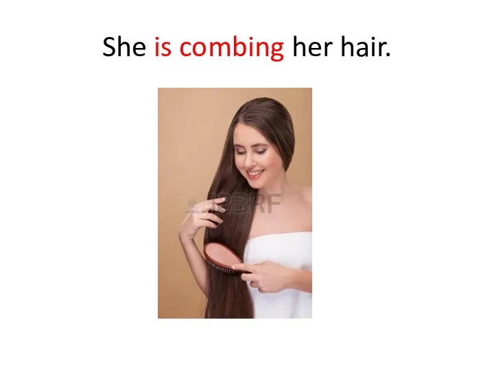She is combing her hair.
