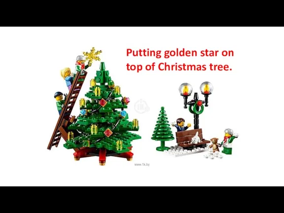 Putting golden star on top of Christmas tree.