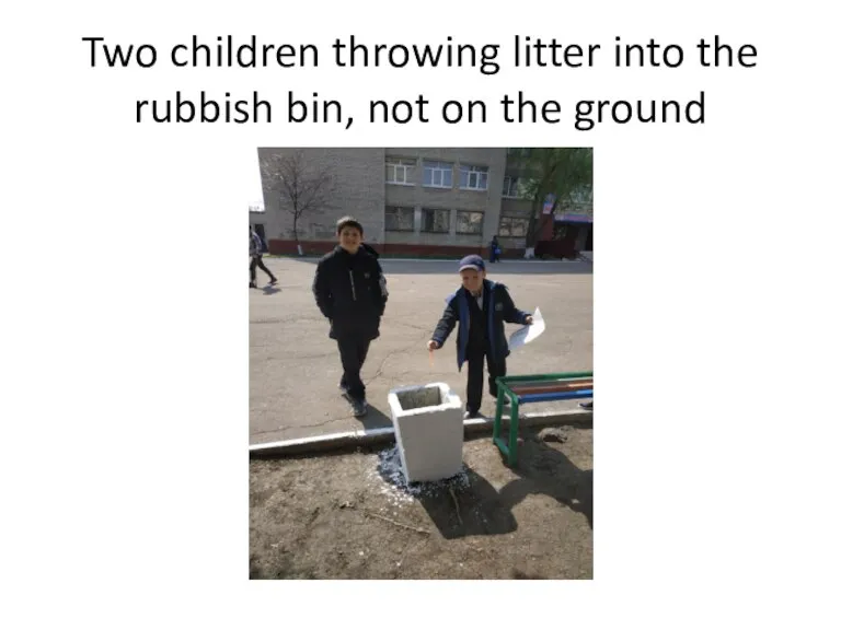Two children throwing litter into the rubbish bin, not on the ground