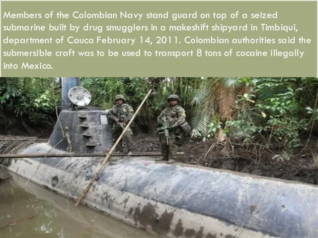 Members of the Colombian Navy stand guard on top of a seized