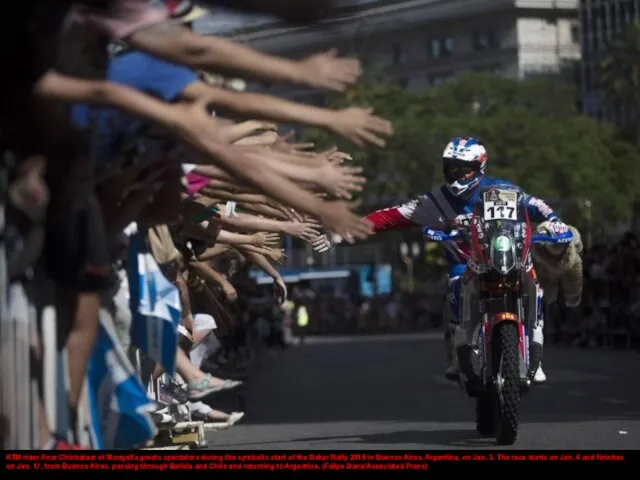 KTM rider Anar Chinbataar of Mongolia greets spectators during the symbolic start
