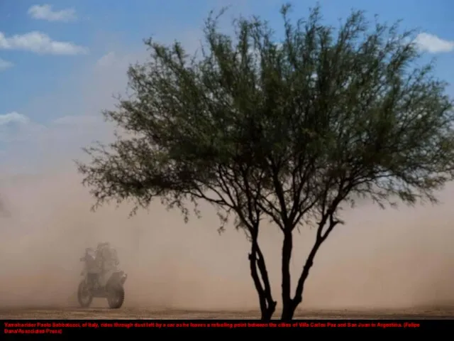 Yamaha rider Paolo Sabbatucci, of Italy, rides through dust left by a