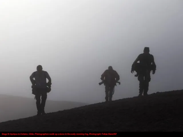 Stage 9: Iquique to Calama, Chile. Photographers walk up a dune in