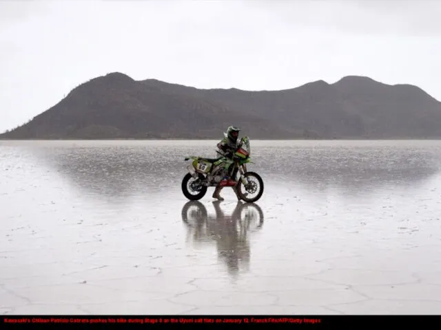 Kawasaki's Chilean Patricio Cabrera pushes his bike during Stage 8 on the