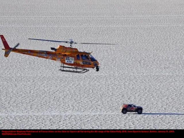 Peugeot driver Stephane Peterhansel of France drives on the Salar de Uyuni