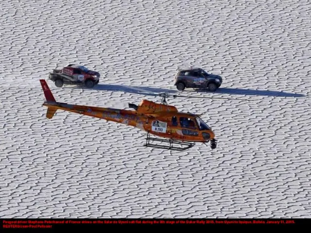 Peugeot driver Stephane Peterhansel of France drives on the Salar de Uyuni