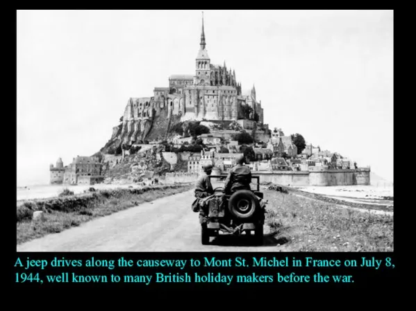 A jeep drives along the causeway to Mont St. Michel in France