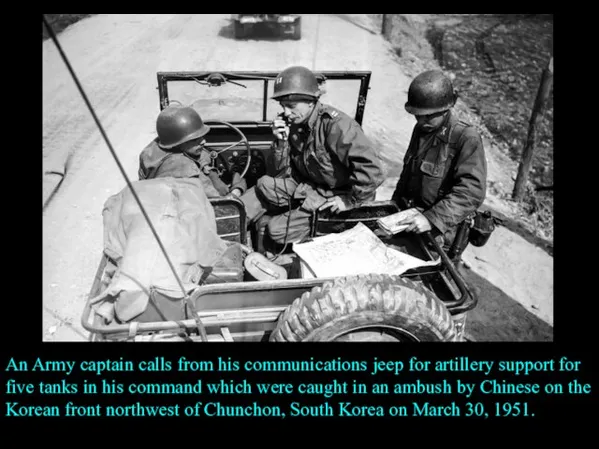 An Army captain calls from his communications jeep for artillery support for