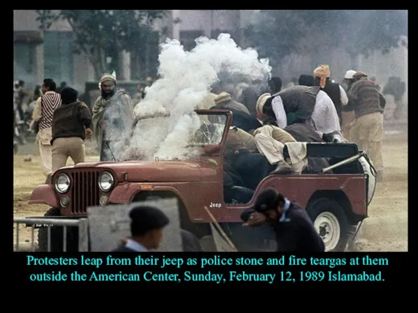 Protesters leap from their jeep as police stone and fire teargas at