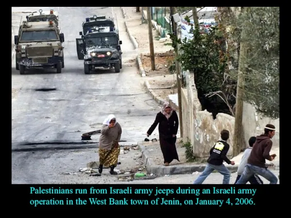 Palestinians run from Israeli army jeeps during an Israeli army operation in