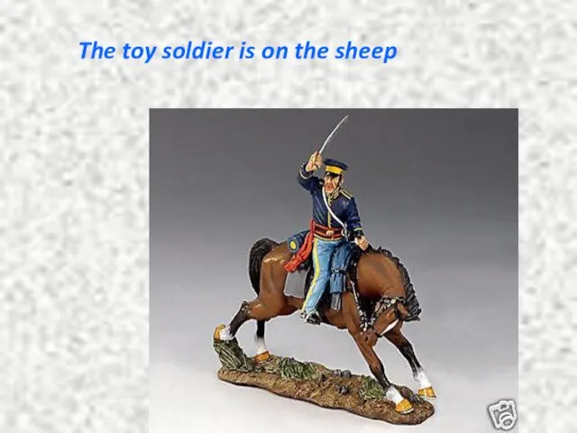 The toy soldier is on the sheep