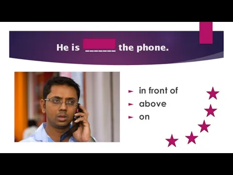 on He is _______ the phone. in front of above on