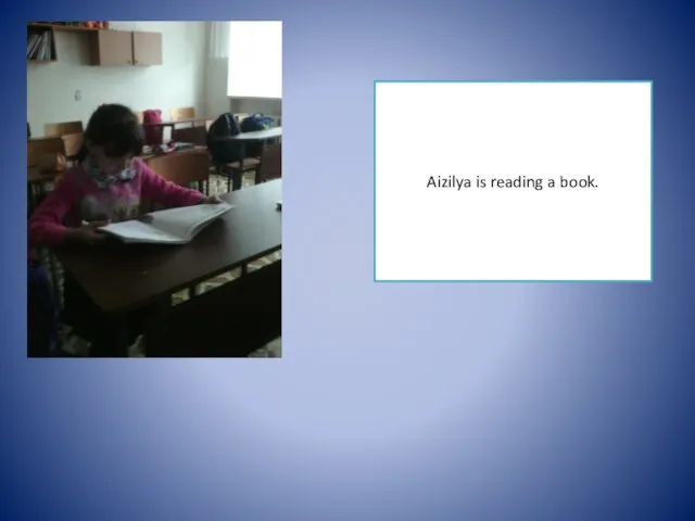 Aizilya is reading a book.