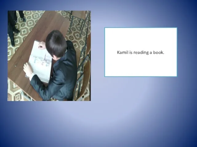 Kamil is reading a book.